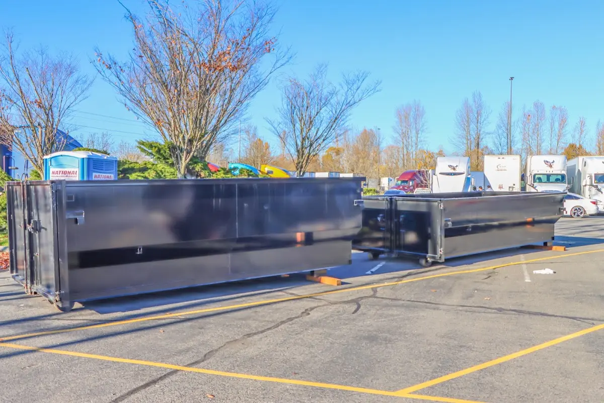 Professional dumpster rental service with roll-off container on residential driveway in Los Alamos